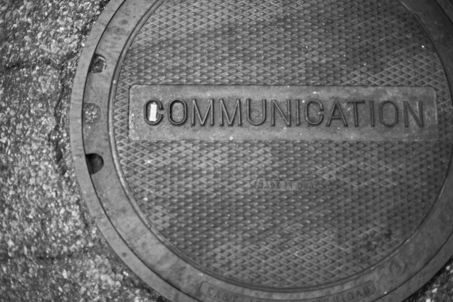Manhole cover with the word communication on it
